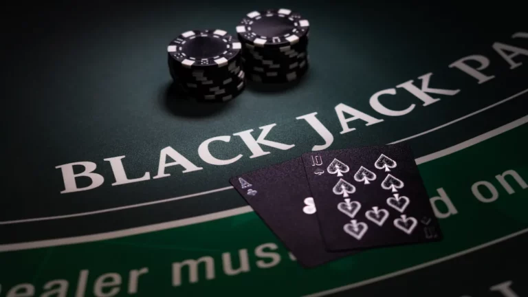 Blackjack table at a casino with cards and chips.